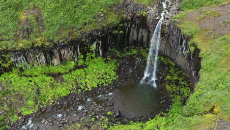Aerial-View-Of-Svartifoss-Waterfall-In-South-Iceland,-situated-in-Skaftafell,-Vatnajökull-National-Park---drone-shot