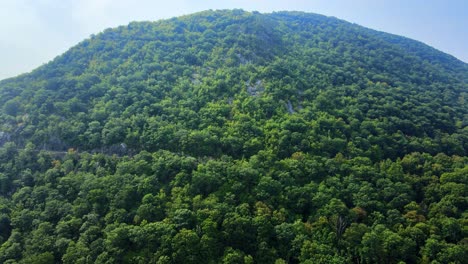 Aerial-drone-video-footage-of-an-Appalachian-mountain-river-valley-with-a-beautiful-domed-mountain-with-a-road