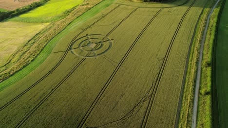 Hackpen-hill-strange-crop-circle-target-pattern-in-rural-grass-farmland-meadow-aerial-view-descending-above-countryside-landscape