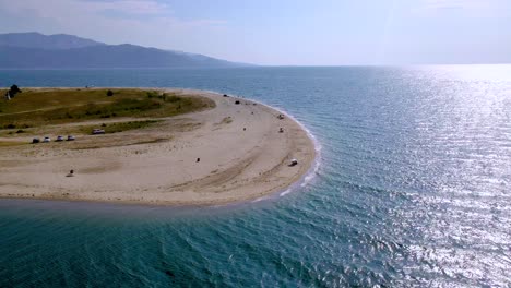 Drone-clip-moving-around-a-tropical-beach-with-golden-sand-in-the-area-of-Keramoti,-Kavala,-in-Northern-Greece-in-4k