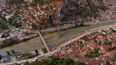 Tilt-up-reveal-of-UNESCO-World-Heritage-Site-of-Berat-in-Albania-with-river