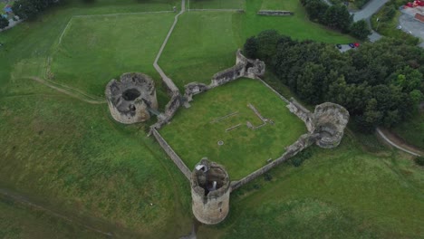 Flint-castle-Welsh-medieval-coastal-military-fortress-ruin-aerial-birdseye-descent-view