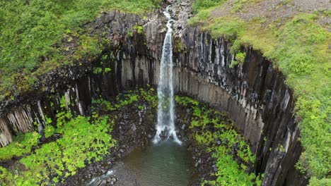 The-Popular-Svartifoss-Waterfall-And-Its-Basalt-Columns,-Skaftafell,-Vatnajökull-National-Park,-Iceland---aerial-drone-shot