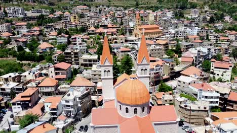 Dome-And-Spires-Of-Saint-Saba-Cathedral-With-Bsharri-Town-On-A-Sunny-Day-In-Lebanon