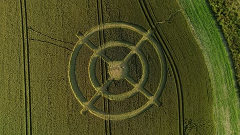 Hackpen-hill-strange-crop-circle-symbols-in-rural-grass-farming-meadow-aerial-view-birdseye-descending-shot