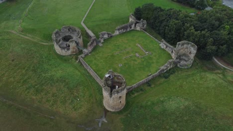 Flint-castle-Welsh-medieval-coastal-military-fortress-ruin-aerial-birdseye-tracking-down-view