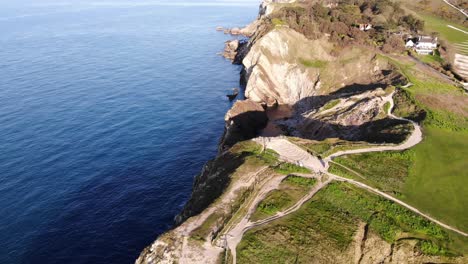 Aerial-forward-view-of-Stair-Hole-at-Lulworth-Cove-Dorset-England-UK