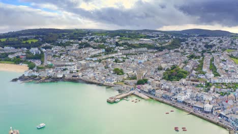 Cinematic-aerial-view-over-the-town-and-harbor-of-St-Ives-in-Cornwall-U