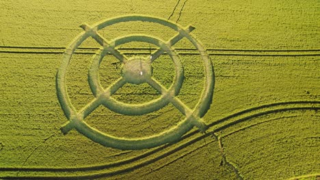 Hackpen-hill-strange-wheat-field-target-crop-circle-design-in-green-harvest-farmland-aerial-view-right-top-down-orbit