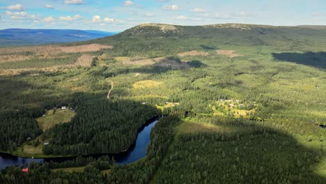 Countryside-Landscape-With-Lush-Vegetation,-Lake-And-Green-Mountain-In-Sälen,-Dalarna,-Sweden---aerial-drone-shot