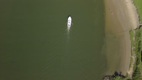 Aerial-drone-view-of-top-down-shot-following-the-boat-at-the-Meuse-river-in-the-Netherlands,-Europe