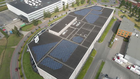 Jib-down-of-warehouse-with-a-lot-of-solar-panels-on-rooftop