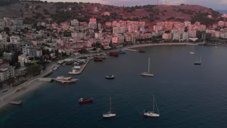 Slow-drone-tilt-up-over-beautiful-Saranda-Bay-with-boats-and-yachts-parked