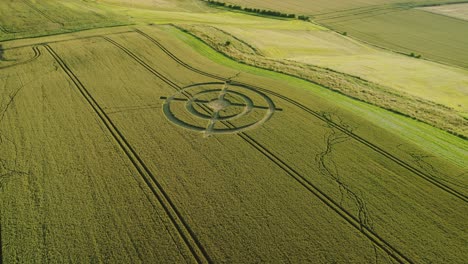 Hackpen-hill-strange-wheat-field-crop-circle-design-in-green-harvest-farmland-aerial-view-left-orbit