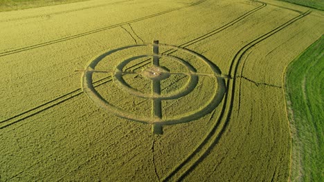 Hackpen-hill-strange-wheat-field-target-crop-circle-design-in-green-farmland-aerial-view-orbiting-right