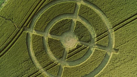 Hackpen-hill-strange-crop-circle-pattern-in-rural-grass-farming-meadow-aerial-view-rising-birdseye