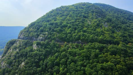 Aerial-drone-video-footage-of-an-Appalachian-mountain-river-valley-with-a-beautiful-domed-mountain-with-a-road