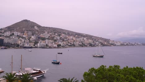 High-rise-concrete-buildings-in-Saranda,-Albania-with-boats
