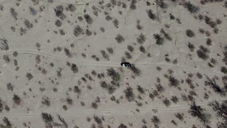 Car-Driving-on-Dirt-Road-in-African-Desert-in-Etosha-National-Park,-Aerial