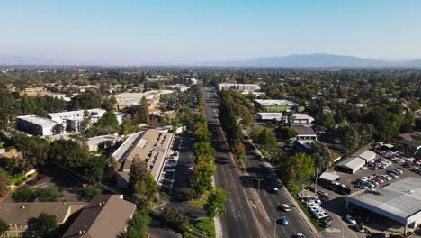 Sunnyvale-City-Aerial-view-with-trees,-main-road,-houses,-and-mountains-in-background-in-the-afternoon