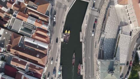 Aerial-top-down-tracking-shot-capturing-activities-along-water-canal-in-downtown-Aveiro
