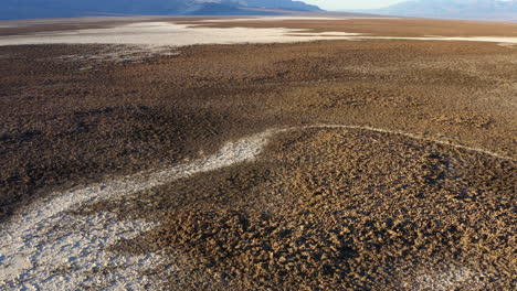 Aerial-over-Devils-golf-course-at-Death-valley-National-Park-showing-rugged-terrain-covered-with-large-salt-pans