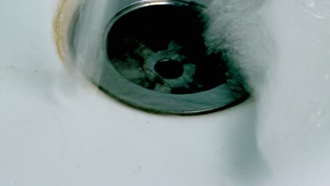 Soap-Suds-Drain-In-Sink---high-angle,-close-up