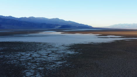 Aerial-over-endless,-raw-and-unprocessed-covering-of-salt-on-valley-floor-at-Badwater-basin-of-Death-Valley-National-Park