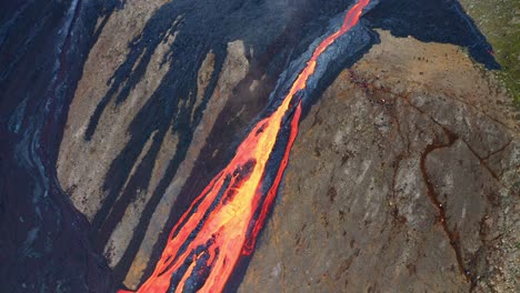 Lava-Flowing-Down-The-Cliff-During-Volcanic-Eruption-At-Mount-Fagradalsfjall,-Southwest-Iceland---aerial-drone-shot
