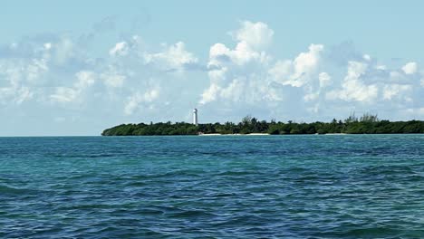 Wide-shot-of-an-isolated-white-tropical-lighthouse-surrounded-by-mangroves-in-the-beautiful-biosphere-ecopark-reserve-Sian-Ka'an-in-Riviera-Maya,-Mexico-near-Tulum-on-a-warm-sunny-summer-day
