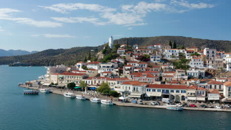 Scenic-View-Of-Buildings-And-Clock-Tower-In-Poros-Island-At-Summer-In-Greece,-wide-aerial
