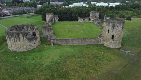 Flint-castle-Welsh-medieval-coastal-military-fortress-ruin-aerial-view-slow-left-rotating-shot