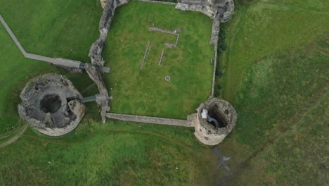 Flint-castle-Welsh-medieval-coastal-military-fortress-ruin-aerial-view-lowering-top-down-shot