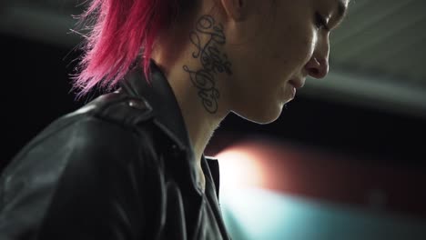 Emo-red-punk-woman-in-black-jacket-with-neck-tattoo