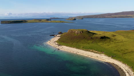 Drone-shot-of-Coral-Beach-in-Claigan-with-white-sandy-beaches-and-tropical-blue-water,-in-Scotland