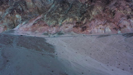 Aerial-shot-of-a-car-driving-through-artist's-drive-in-Death-Valley