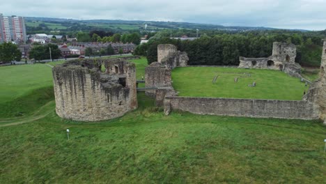 Flint-castle-Welsh-medieval-coastal-military-fortress-ruin-aerial-view-rotation-right-low-angle