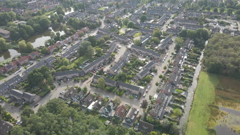 Aerial-of-a-peaceful-suburban-neighborhood-in-a-green-area-with-ponds-and-forest