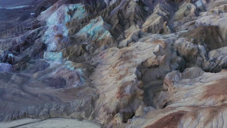 Aerial-tilt-up-reveal-of-Artist's-Palette-at-Artist's-Drive-in-Death-Valley,-California