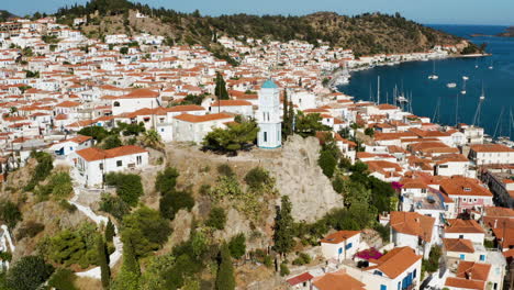 Aerial-View-Of-Poros-Clock-Tower-And-Houses-In-Island-During-Summer-In-Greece