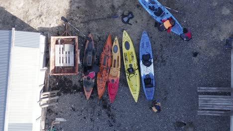 Guys-unloading-kayaks-after-returning-from-adventure-trip-in-Iceland,-top-down
