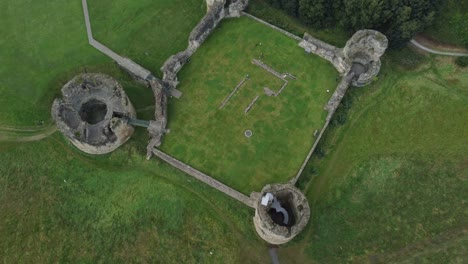 Flint-castle-Welsh-medieval-coastal-military-fortress-ruin-aerial-view-top-down-rotating-left