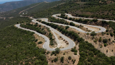 Cars-Traveling-By-The-Winding-Mountain-Pass-On-A-Sunny-Day-In-Peloponnese,-Greece