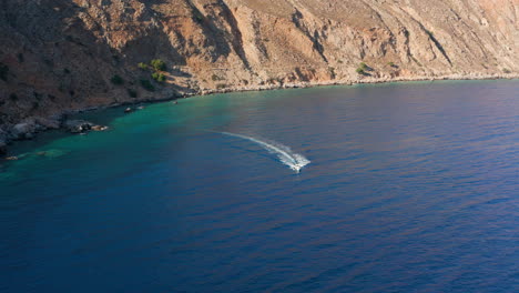 Speedboat-Cruising-At-Calm-Blue-Sea-Towards-Loutro-Village-In-Chania,-Greece