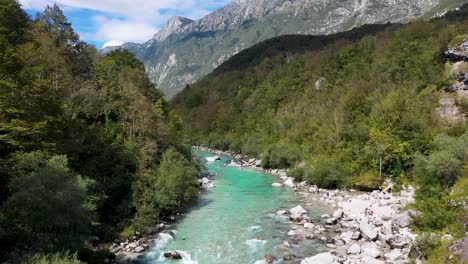Slovenia,-turquoise-river-with-forest-and-mountain