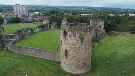 Flint-castle-Welsh-medieval-coastal-military-fortress-ruin-aerial-view-rising-tilt-down