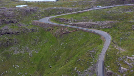 Cinematic-drone-shot-of-twisting-road-on-Bealach-Na-Ba-Applecross-road-through-the-mountains-of-the-Applecross-peninsula,-in-Wester-Ross-in-the-Scottish-Highlands