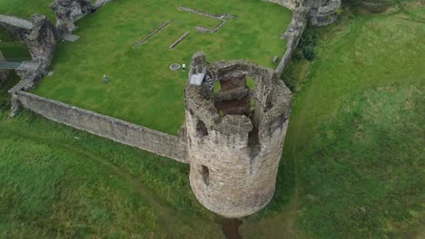 Flint-castle-Welsh-medieval-coastal-military-fortress-ruin-aerial-view-rising-birdseye-over-turret