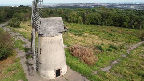 Bidston-hill-disused-rural-flour-mill-restored-traditional-wooden-sail-windmill-Birkenhead-aerial-view-close-left-orbit