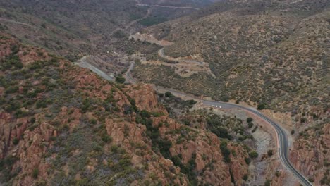 Aerial-moving-up-mountain-on-highway-89-winding-switchbacks-Jerome-AZ,-4K